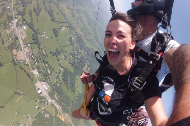 Women smiling with glee while under canopy with Chattanooga Skydiving Company's tandem instructor