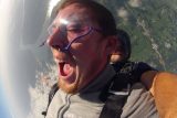 Man wearing clear skydiving googles in freefall with Chattanooga Skydiving Company tandem instructor