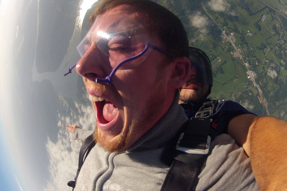 Man wearing clear skydiving googles in freefall with Chattanooga Skydiving Company tandem instructor