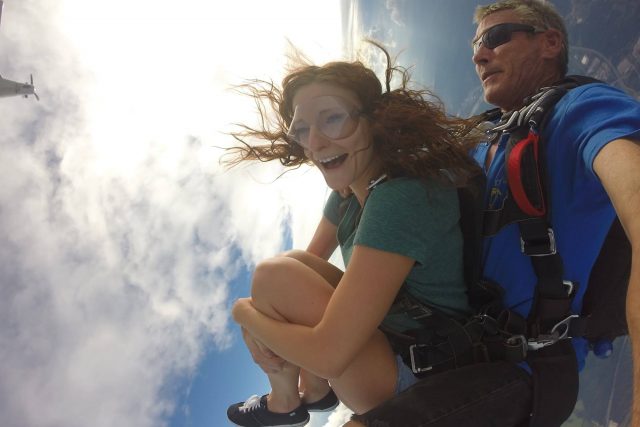 Women in green shirt takes the leap out of the Chattanooga Skydiving Company airplane
