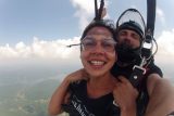 Women smiling during the canopy ride portion of her skydive at Chattanooga Skydiving Company