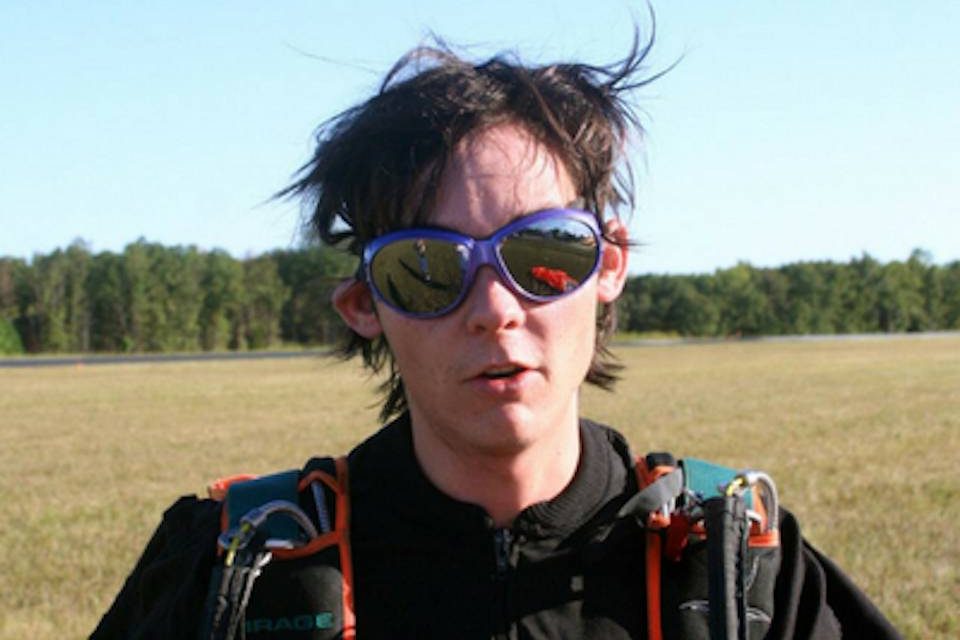 Paul Silvia wearing skydiving gear and googles after landing a skydive