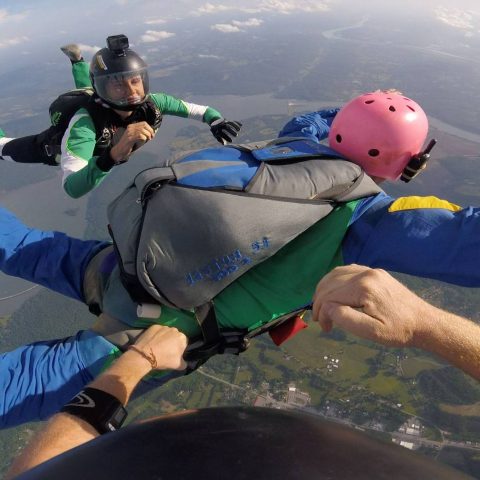 Man wearing pink helmet in freefall during AFF training at Chattanooga Skydiving Company