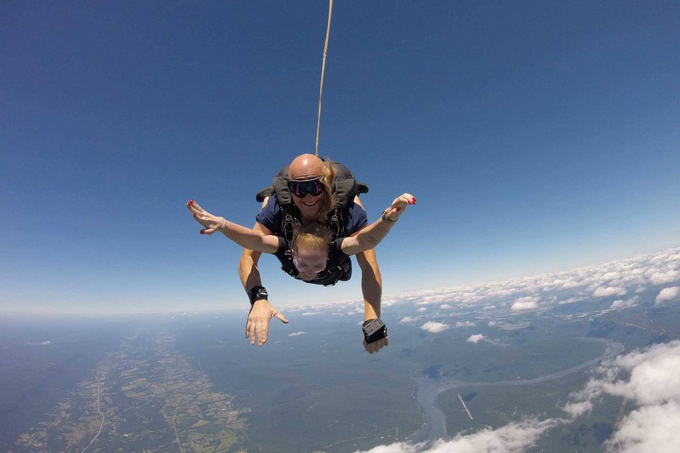 Women excitedly reaches out her arms during skydive at Chattanooga Skydiving Company