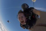 Women enjoys the rush of freefall with tandem instructor