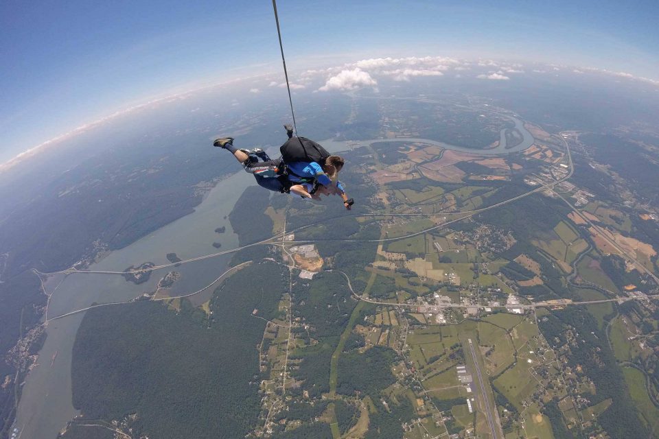 Male tandem skydiver stretches arms out while enjoying his skydive at Chattanooga Skydiving Company