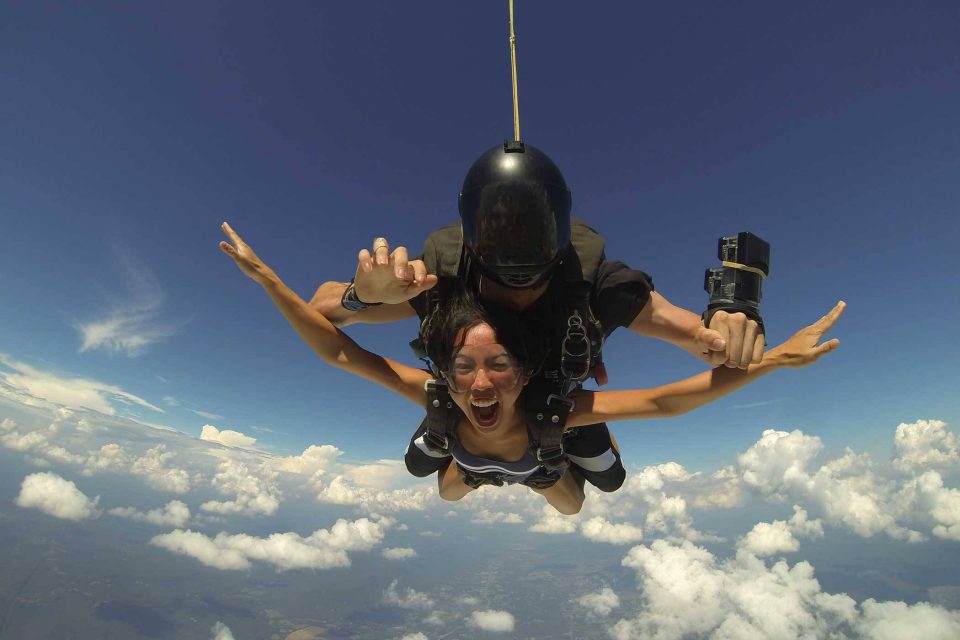 Female holds her arms out in excitement during free fall