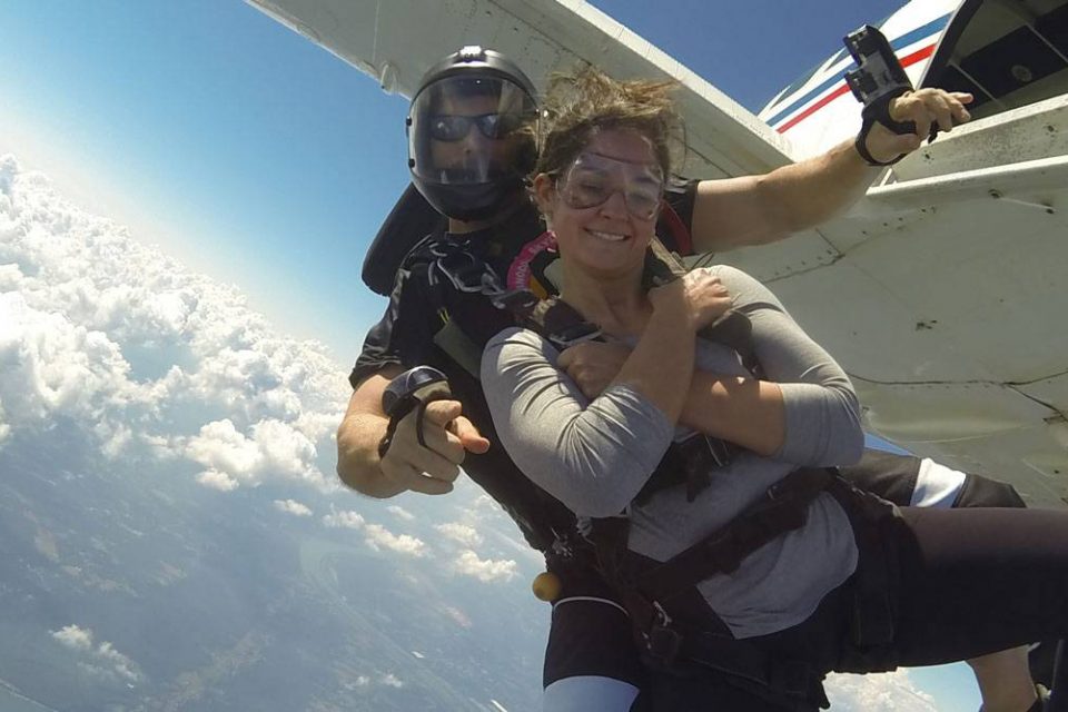 Female wearing gray shirt takes the jump out of the Chattanooga Skydiving Company aircraft